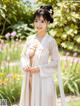 A woman in a white dress posing for a picture.