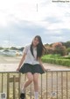 A young woman in a school uniform posing for a magazine.